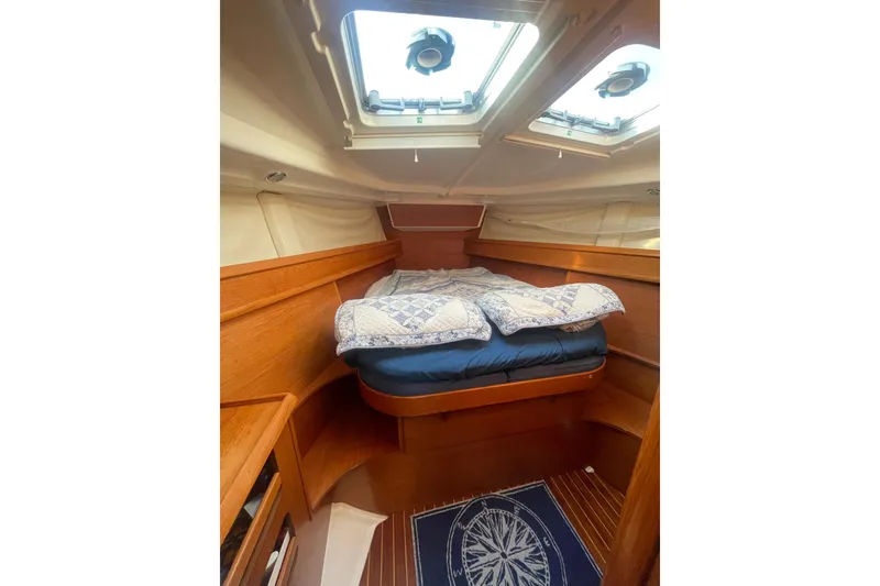 Slide: The Image of Cozy cabin interior of 2006 Jeanneau Sun Odyssey 45 sailboat with skylights and bedding. - 17