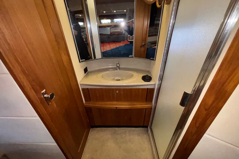 Slide: The Image of Bathroom interior of 1996 Bayliner 3587 Motoryacht with wooden cabinetry and sink. - 17