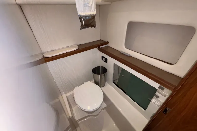 Slide: The Image of Bathroom interior of 1996 Bayliner 3587 Motoryacht with toilet and mirror. - 18
