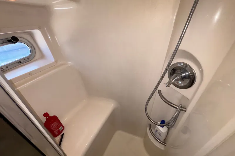 Slide: The Image of Shower area in 1996 Bayliner 3587 Motoryacht with window and toiletries. - 19