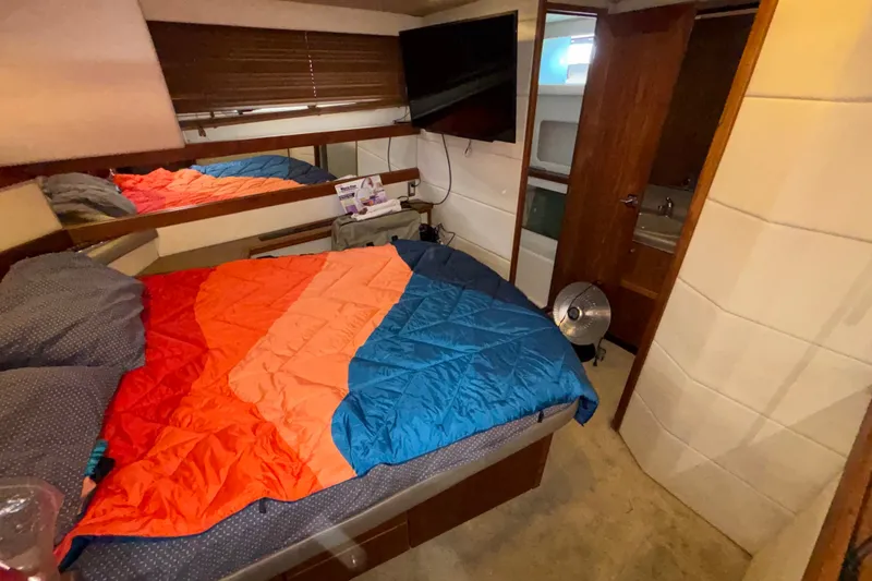 Slide: The Image of Cozy bedroom in 1996 Bayliner 3587 Motoryacht with colorful bedding and modern amenities. - 16