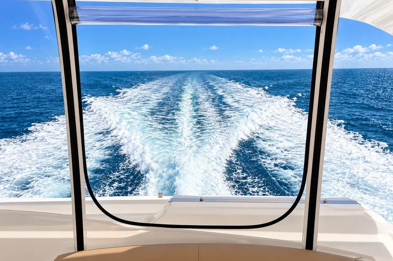 Slide: The Image of View from Horizon 62 Motor Yacht, 2003, showing ocean wake under clear blue sky. - 65