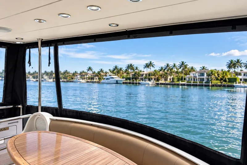 Slide: The Image of Luxurious view from 2003 Horizon 62 Motor Yacht, overlooking serene waterfront and palm trees. - 72