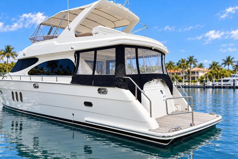 Slide: The Image of 2003 Horizon 62 Motor Yacht docked in sunny marina with palm trees. - 2