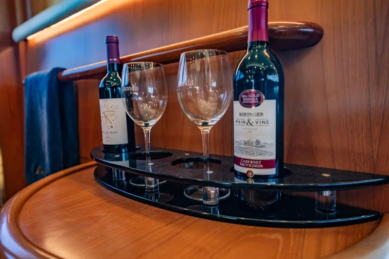 Slide: The Image of Zwei Weinflaschen und Gläser auf einem eleganten Regal im Inneren einer Yacht. - 16