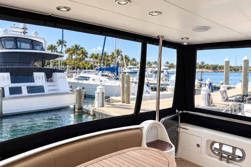 Slide: The Image of Luxurious 2003 Horizon 62 Motor Yacht interior view at marina with docked boats. - 61