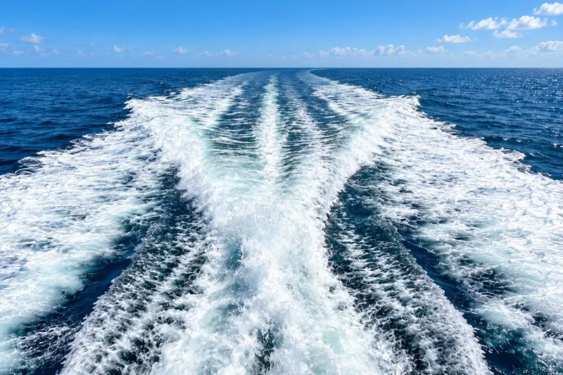 Slide: The Image of Wake trail of a 2003 Horizon 62 Motor Yacht on open sea. - 66