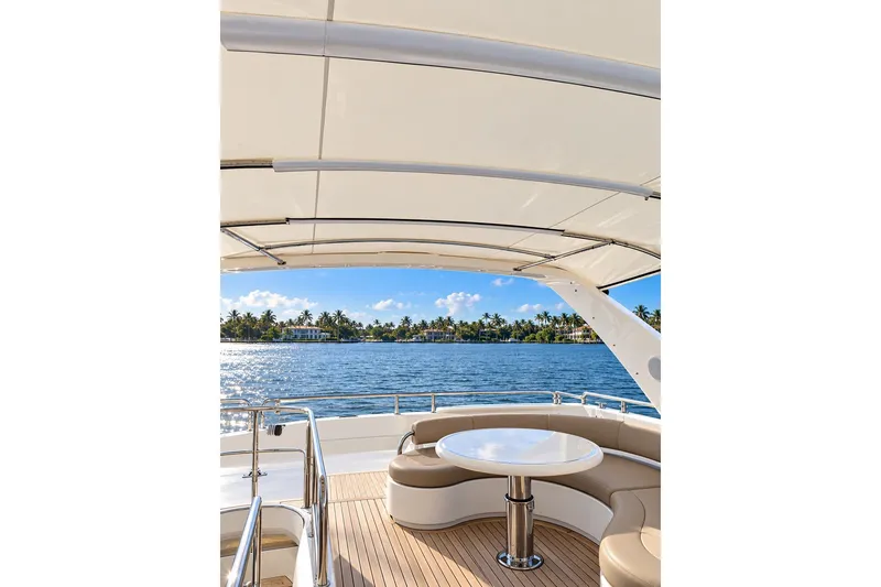 Slide: The Image of Luxurious Horizon 62 Motor Yacht deck with seating, ocean view, and palm trees, 2003 model. - 73