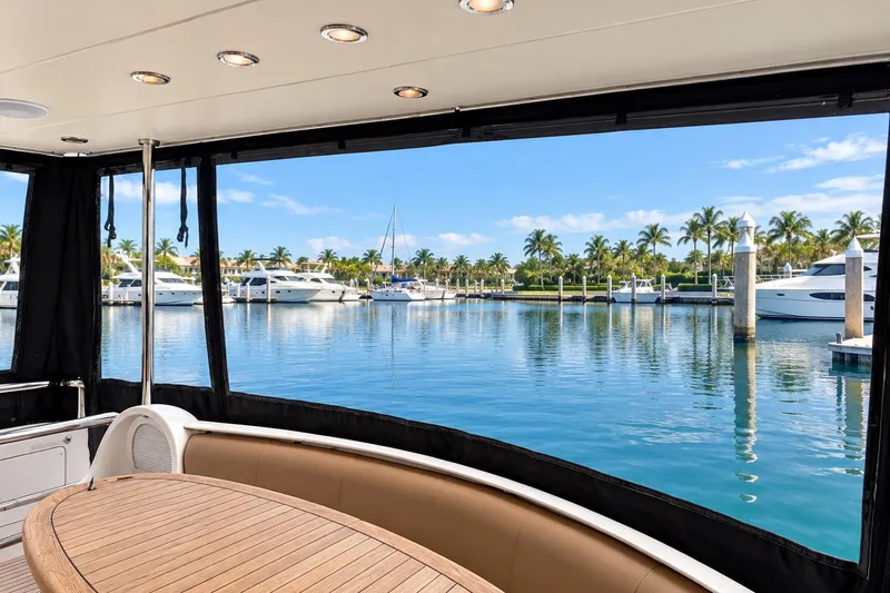 Slide: The Image of Luxurious 2003 Horizon 62 Motor Yacht with marina view and elegant seating area. - 60
