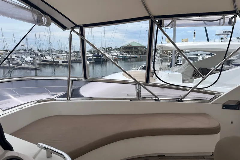 Slide: The Image of 2003 Horizon E62 Motor Yacht interior with marina view, featuring comfortable seating and sleek design. - 72