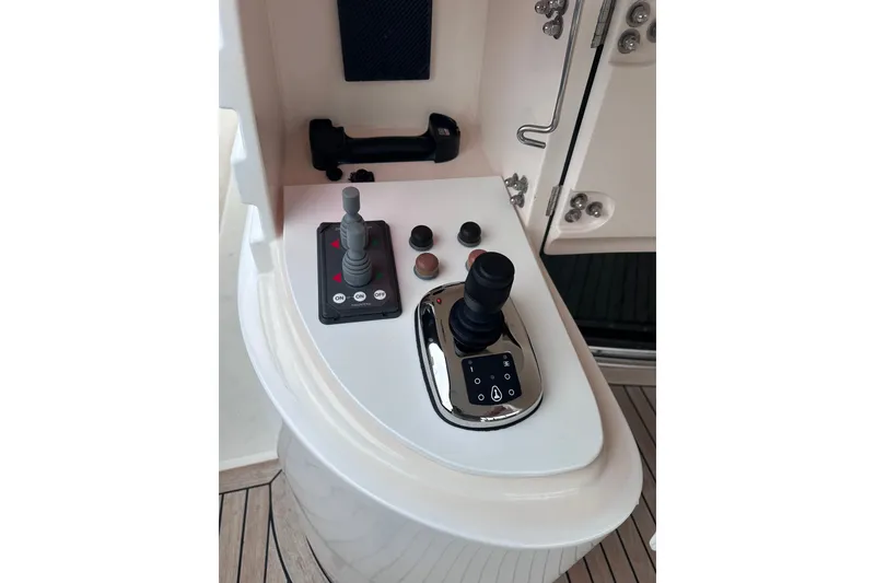Slide: The Image of Control panel of a 2003 Horizon E62 Motor Yacht with joystick and buttons. - 81