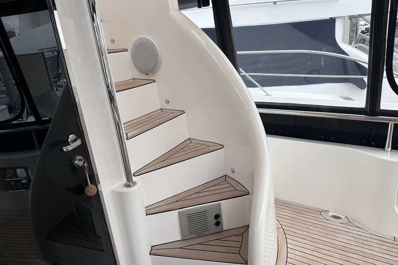 Slide: The Image of Staircase on 2003 Horizon E62 Motor Yacht with wooden steps and sleek design. - 79