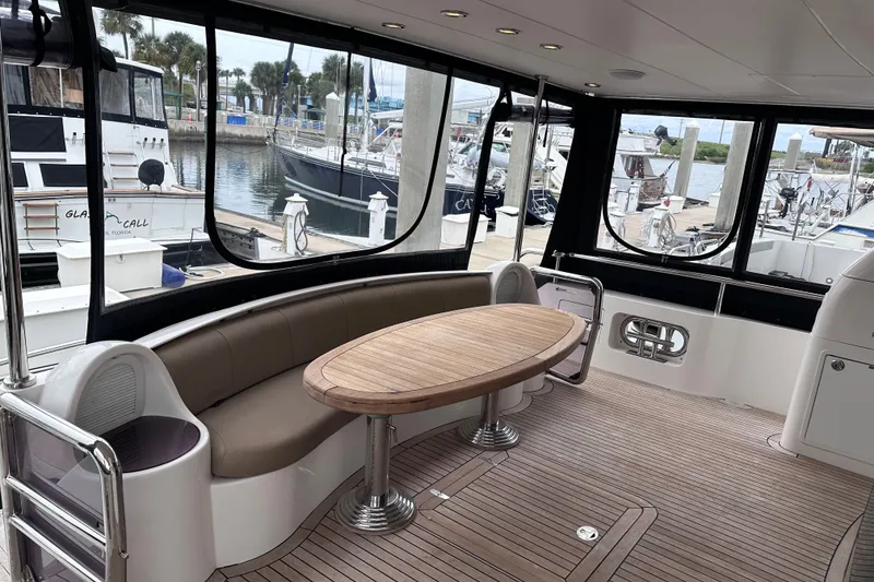 Slide: The Image of Luxurious interior of 2003 Horizon E62 Motor Yacht with elegant seating and wooden table. - 85