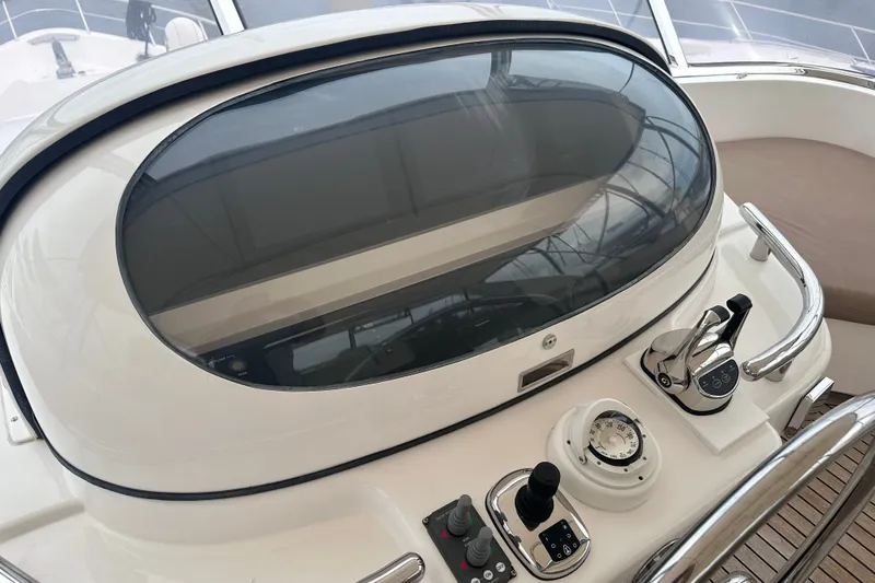 Slide: The Image of Control panel of a 2003 Horizon E62 Motor Yacht, featuring navigation and throttle controls. - 76
