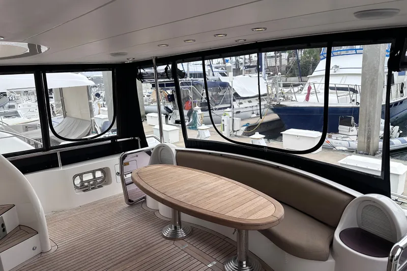 Slide: The Image of Interior of 2003 Horizon E62 Motor Yacht with elegant seating and marina view. - 86