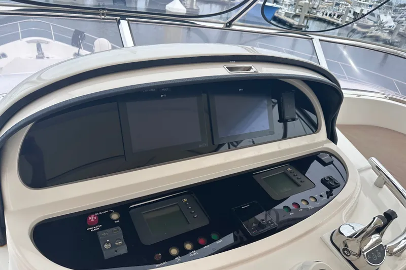 Slide: The Image of Control panel of a 2003 Horizon E62 Motor Yacht, featuring navigation and monitoring systems. - 75