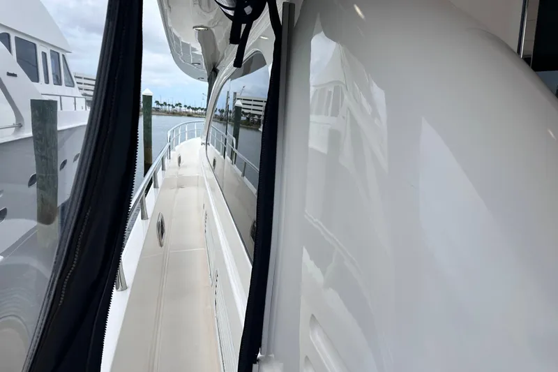 Slide: The Image of Side view of a 2003 Horizon E62 Motor Yacht docked at a marina. - 87