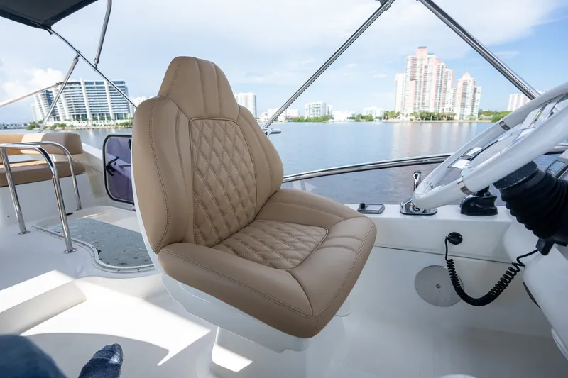 Slide: The Image of Luxurious helm seat on 2014 Azimut 48 yacht, overlooking waterfront cityscape. - 34