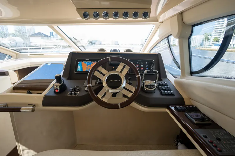 Slide: The Image of Helm of 2014 Azimut 48 yacht with modern navigation controls and steering wheel. - 23