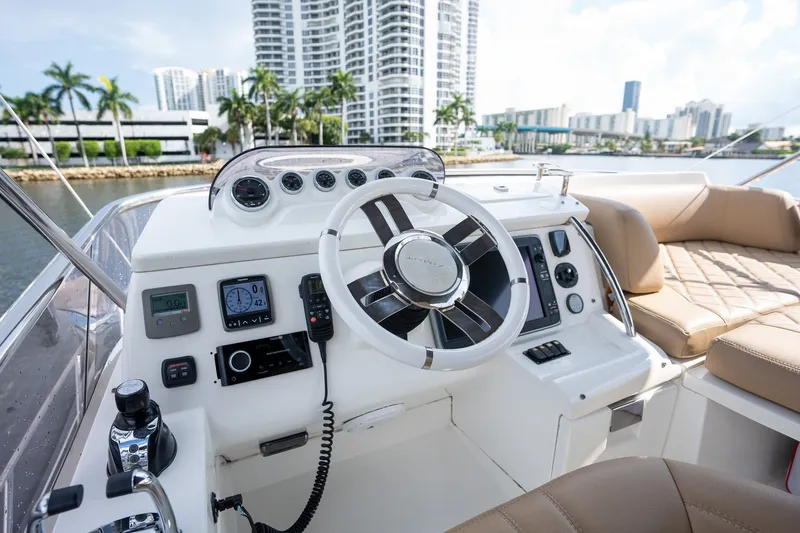 Slide: The Image of Helm of 2014 Azimut 48 yacht with modern controls, overlooking waterfront cityscape. - 31