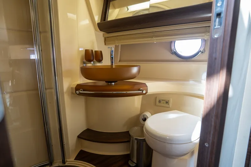 Slide: The Image of Luxurious bathroom in a 2014 Azimut 48 yacht, featuring modern fixtures and elegant design. - 18