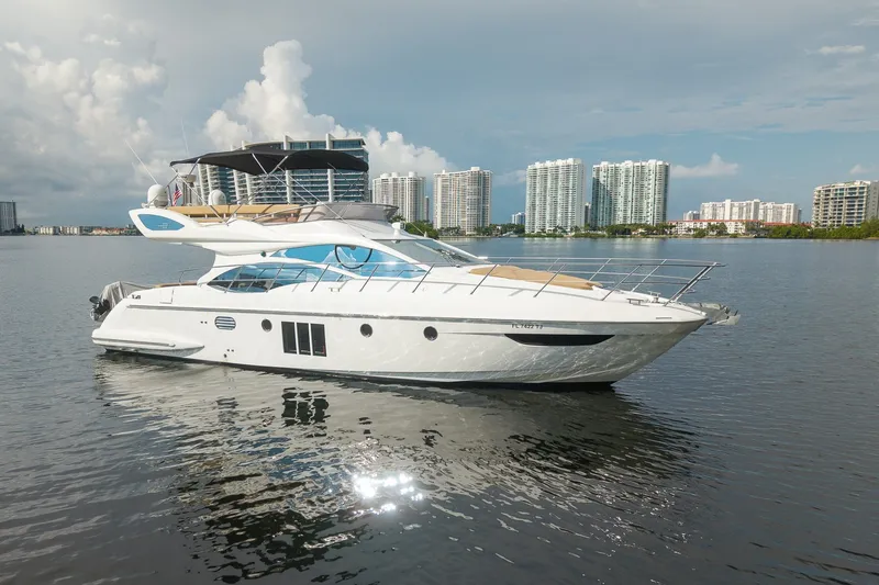 The Image of Luxury 2014 Azimut 48 yacht on calm water with city skyline backdrop. - 0