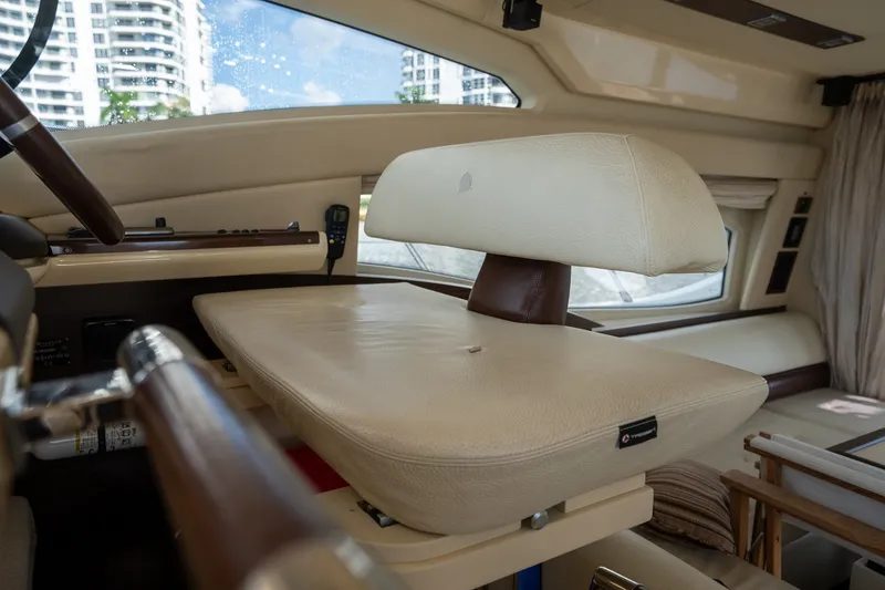 Slide: The Image of Luxurious interior of a 2014 Azimut 48 yacht, featuring a plush beige helm seat. - 27