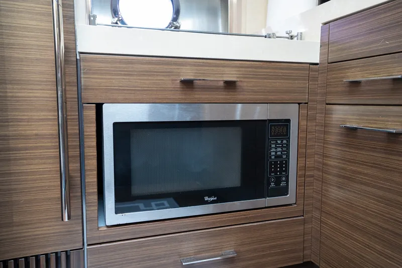 Slide: The Image of Built-in microwave in 2014 Azimut 48 yacht kitchen with wood cabinetry. - 17