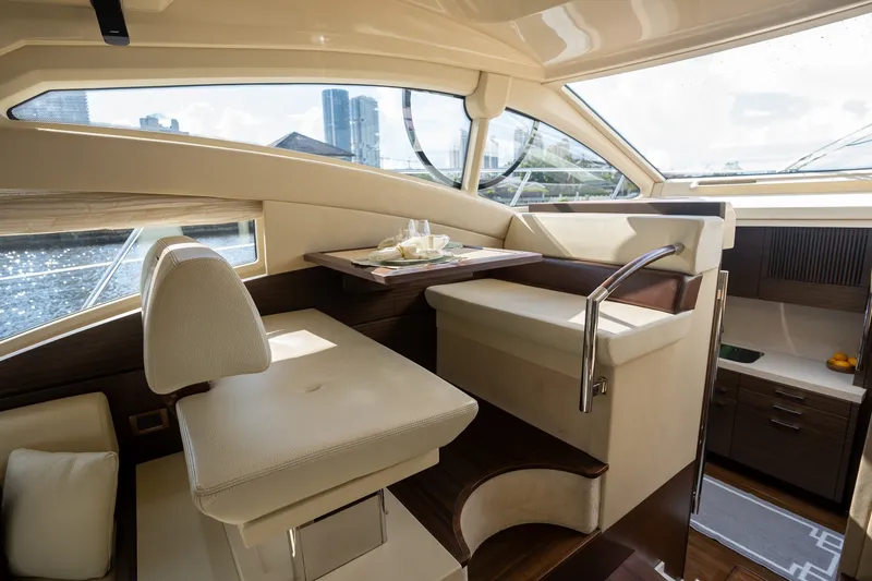 Slide: The Image of Luxurious interior of a 2014 Azimut 48 yacht with elegant seating and dining area. - 25