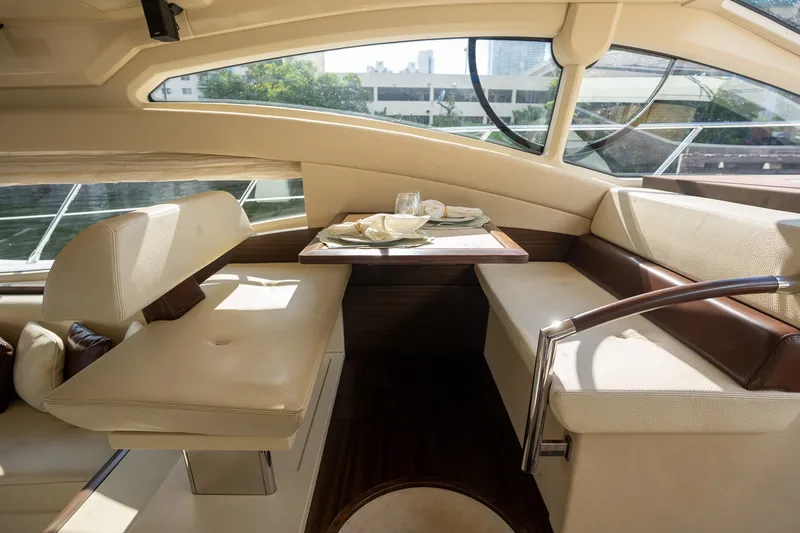 Slide: The Image of Luxurious interior of 2014 Azimut 48 yacht with elegant dining area and plush seating. - 21