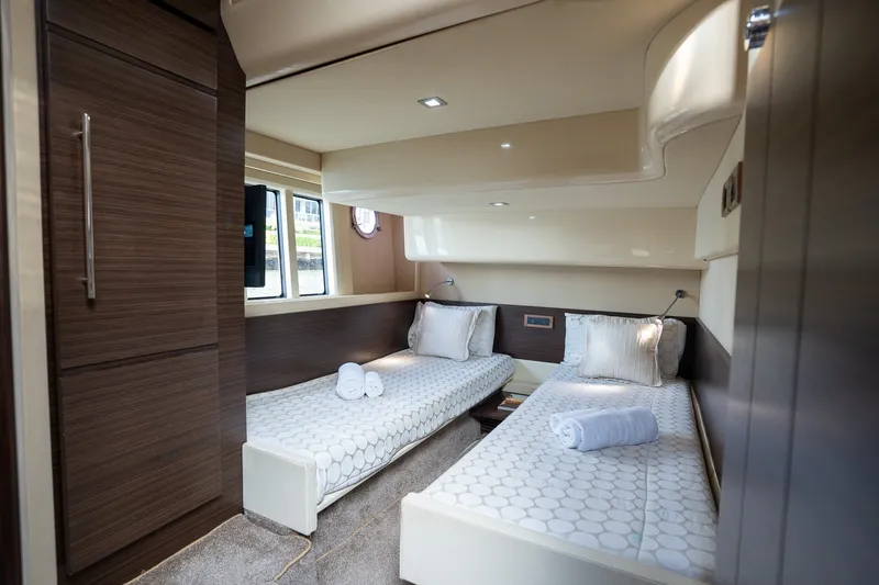 Slide: The Image of Luxurious 2014 Azimut 48 yacht cabin with twin beds and elegant wood finishes. - 15