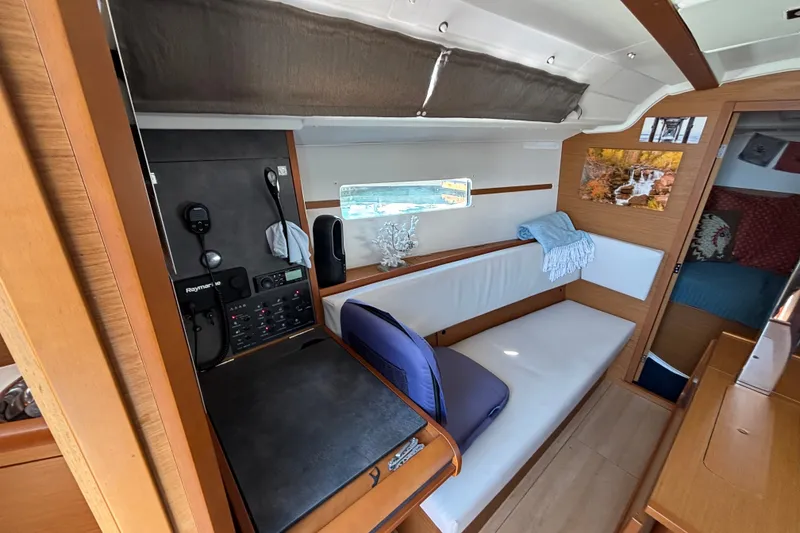 Slide: The Image of Interior of 2023 Jeanneau Sun Odyssey 349 sailboat with navigation equipment and cozy seating area. - 15