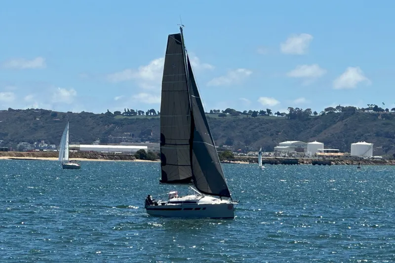 The Image of 2023 Jeanneau Sun Odyssey 349 sailing on a sunny day with hills in the background. - 0