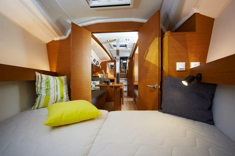 Slide: The Image of Interior cabin of 2023 Jeanneau Sun Odyssey 349 sailboat with cozy bedding and wooden finish. - 22