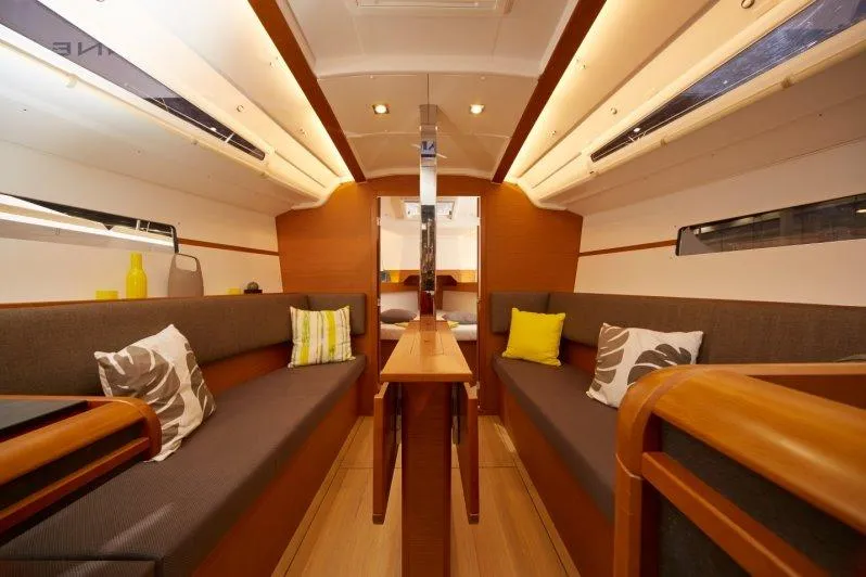 Slide: The Image of Interior of 2023 Jeanneau Sun Odyssey 349 sailboat with modern seating and wooden finishes. - 18