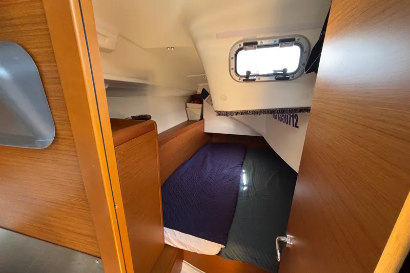 Slide: The Image of Cozy cabin interior of 2023 Jeanneau Sun Odyssey 349 sailboat with wooden finish. - 13