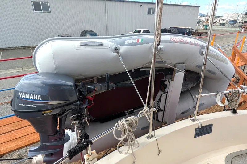 Slide: The Image of Inflatable dinghy with Yamaha outboard motor on a 1993 Nordic Tug 32 boat. - 52