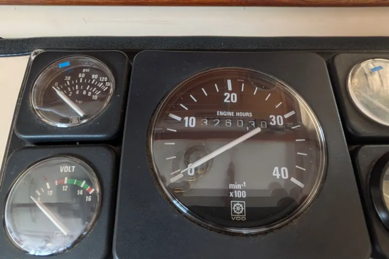 Slide: The Image of Close-up of 1993 Nordic Tug 32 engine gauges displaying hours, voltage, and pressure. - 28
