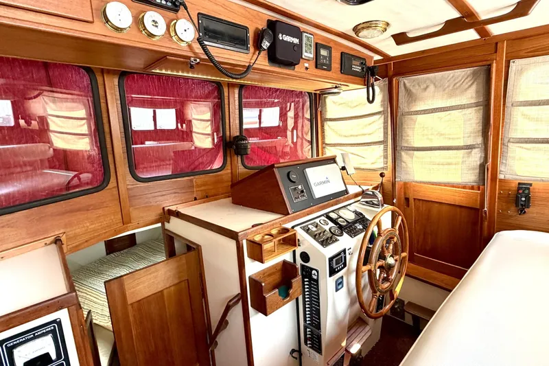 Slide: The Image of Interior of a 1993 Nordic Tug 32 boat with wooden helm and navigation instruments. - 22
