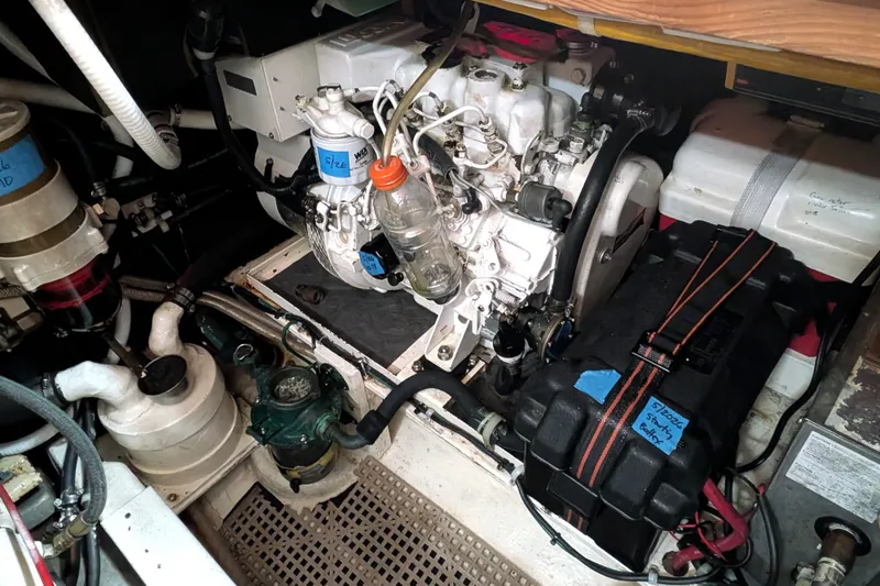 Slide: The Image of Engine room of a 1993 Nordic Tug 32, showcasing mechanical components and wiring. - 45