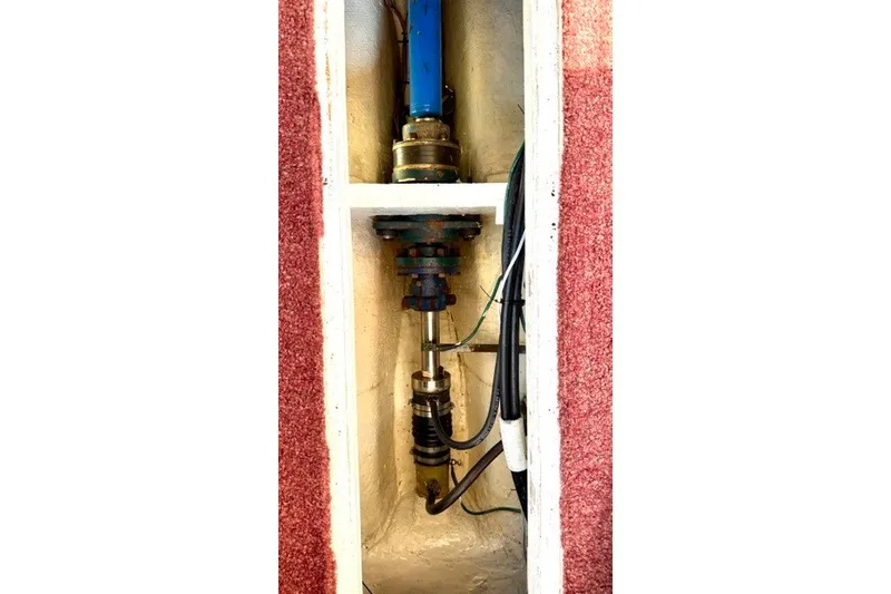 Slide: The Image of Engine compartment of a 1993 Nordic Tug 32, showcasing mechanical components and wiring. - 47