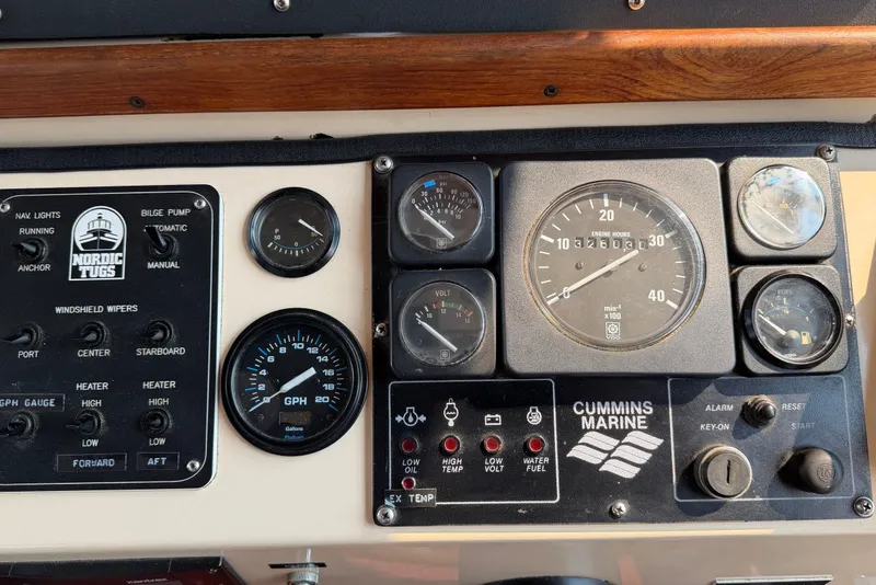 Slide: The Image of Control panel of a 1993 Nordic Tug 32 with Cummins Marine gauges and switches. - 27