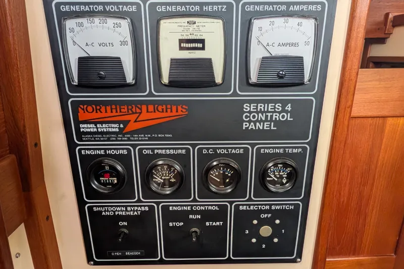 Slide: The Image of Control panel of a 1993 Nordic Tug 32 with generator and engine gauges. - 21