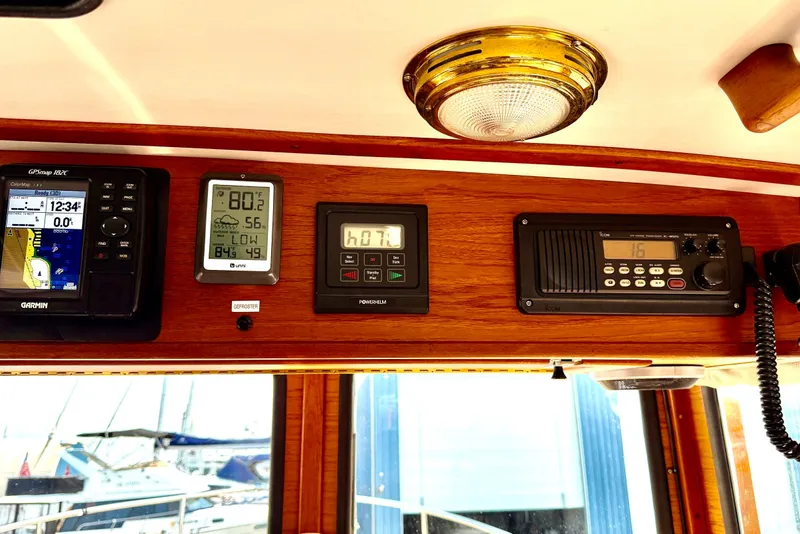 Slide: The Image of Control panel of a 1993 Nordic Tug 32 with navigation and communication instruments. - 32