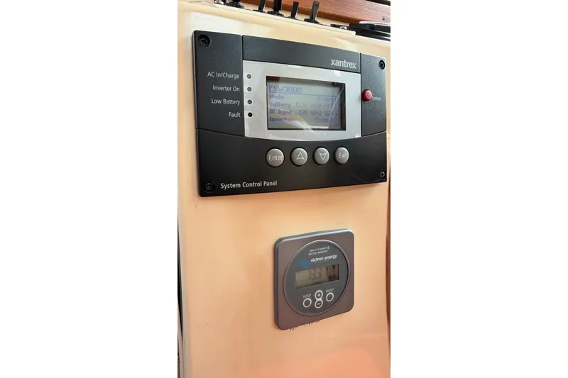 Slide: The Image of Control panel of a 1993 Nordic Tug 32 boat with Xantrex and Victron Energy displays. - 34