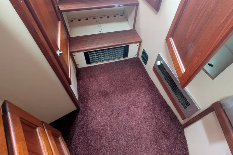 Slide: The Image of Interior of a 1993 Nordic Tug 32 with carpeted floor and wooden steps. - 40