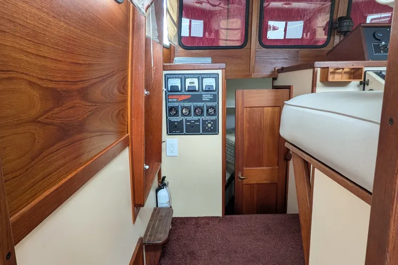 Slide: The Image of Interior of a 1993 Nordic Tug 32, featuring wood paneling and control panels. - 20