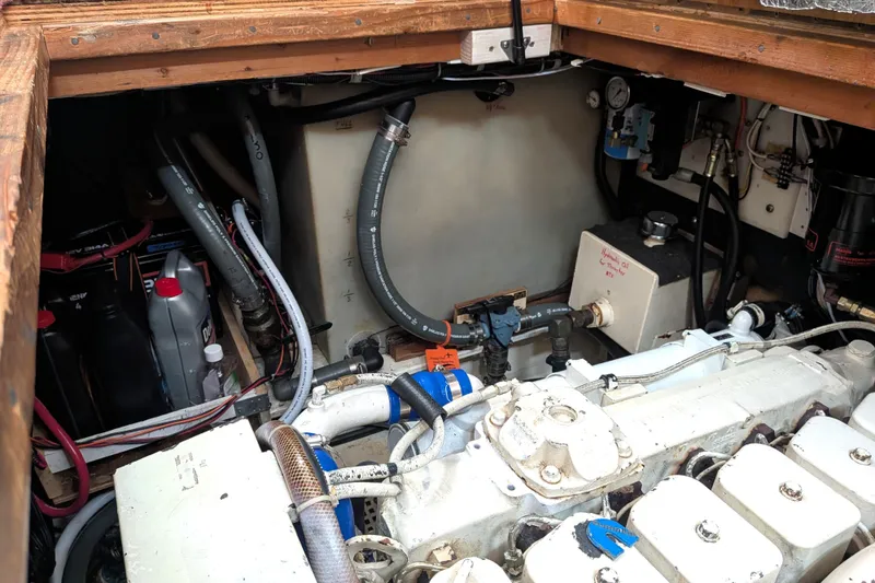 Slide: The Image of Engine compartment of a 1993 Nordic Tug 32, showcasing mechanical components and wiring. - 46