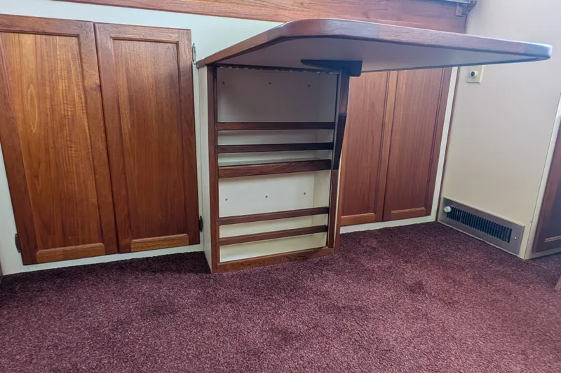 Slide: The Image of Interior of 1993 Nordic Tug 32 with wooden cabinets and foldable table. - 16