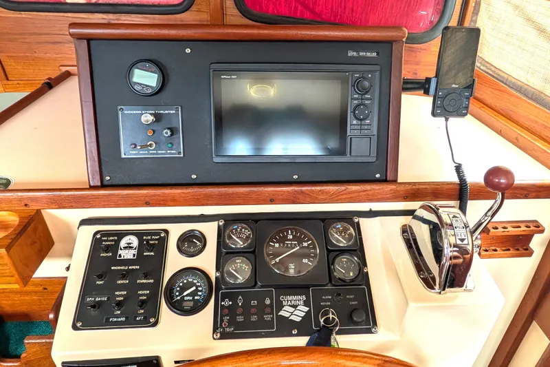 Slide: The Image of Control panel of a 1993 Nordic Tug 32 with navigation and engine gauges. - 26